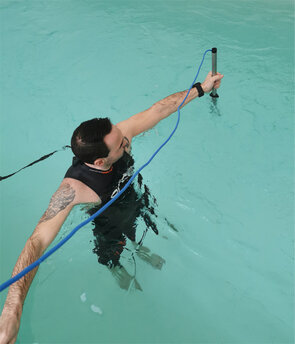 Competitive athlete measuring flow velocity in a pool