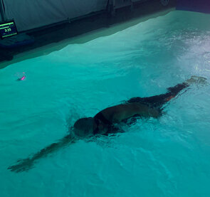 Competitive swimmer in his own outdoor pool